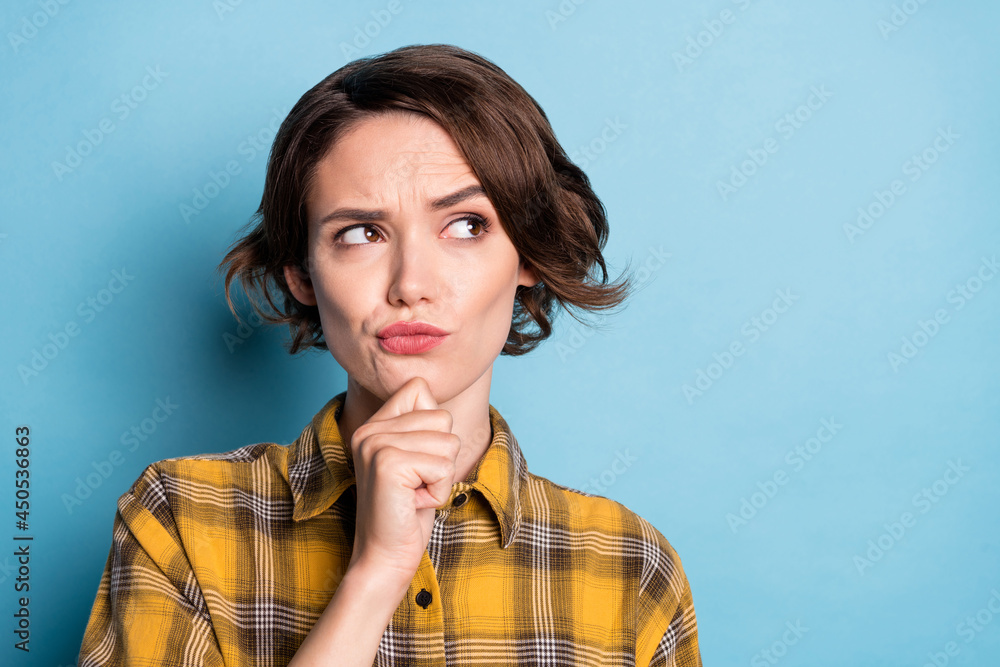 Sticker photo of minded creative doubtful girl finger chin look empty space wear plaid shirt isolated blue c