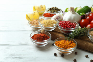 Concept of aromatic spices on white wooden table