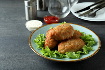 Concept of tasty food with cutlets on dark wooden table