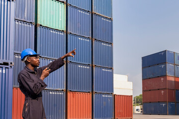 black african amarican man worker working control loading freight containers at commercial shipping...