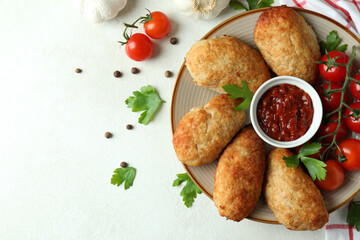 Concept of tasty food with cutlets on white textured table