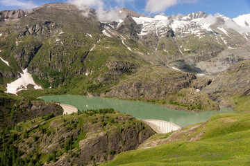 Naklejka na ściany i meble Dam of the Margaritze Reservoir underneath the Grossglockner Mountain. Austria. Europe