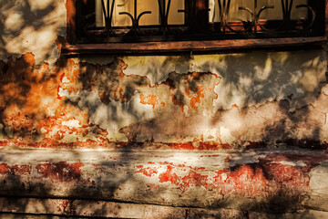 Multicolored old wall in rays of evening sun