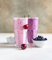 Cherry and blueberry smoothie in glass with straw. Healthy breakfast.