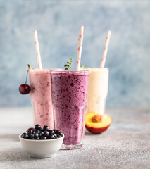 Colorful various smoothie or milkshake with assorted ingredients served in glasses with straw. Healthy food concept.