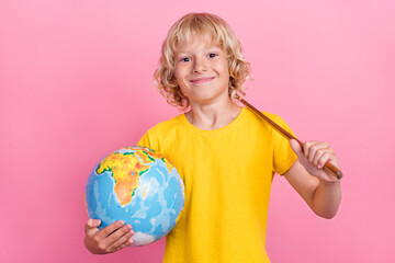 Photo of young school boy happy positive smile hold globe stick education isolated over pink color background