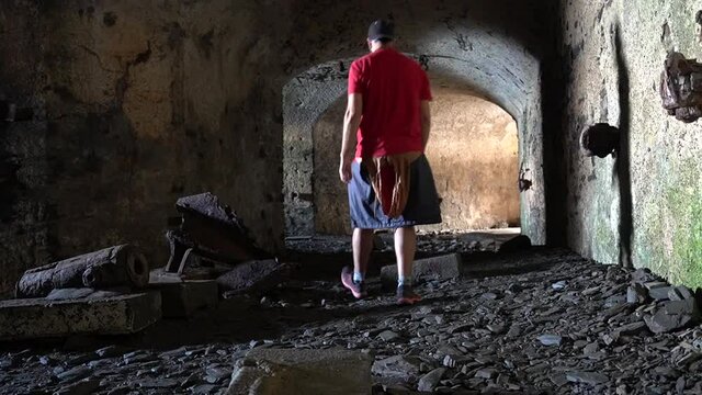 A young man in the bunker in the basement at the Fort des Capucins a rocky islet located in the Atlantic Ocean at the foot of the cliff in the town of Roscanvel on the Crozon peninsula in France.