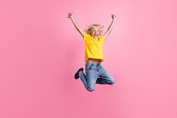 Full body photo of young cheerful school boy happy positive smile jump rejoice victory isolated over pink color background