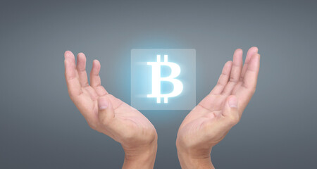 Hands showing bitcoin icon as virtual money digital