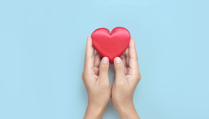 Hands holding red heart. heart health donation concepts