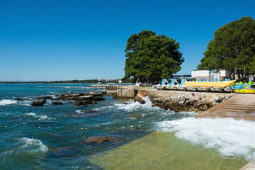 The summer coast just north of the historic centre of Porec on the Istria coast of Croatia
