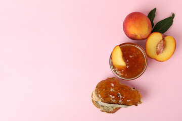 Sandwich with peach jam and ingredients on pink background