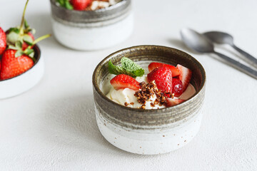 Strawberry, cream cheese and feta cream and crumble crust dessert. Homemade Sweet and salty cheesecake. Trifle. Selective focus