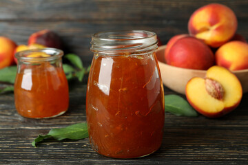 Peach jam and ingredients on rustic wooden table