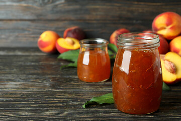 Peach jam and ingredients on rustic wooden table