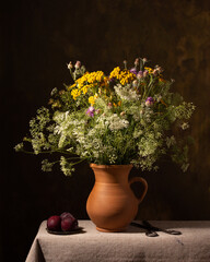 Still life with a bouquet of flowers in a ceramic jug