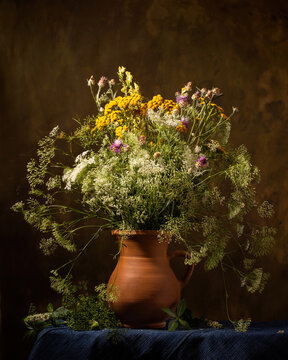 Still life with a bouquet of flowers in a ceramic jug