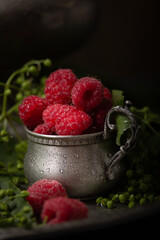 Vintage still life with raspberries and unripe elderberries