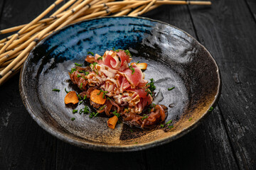 Tuna is baked and sliced ​​on a dark table
