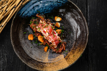 Tuna is baked and sliced ​​on a dark table
