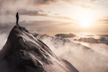 Adventure Sport Concept Composite. Man Standing on top of Rocky Mountain Cliff overlooking the...