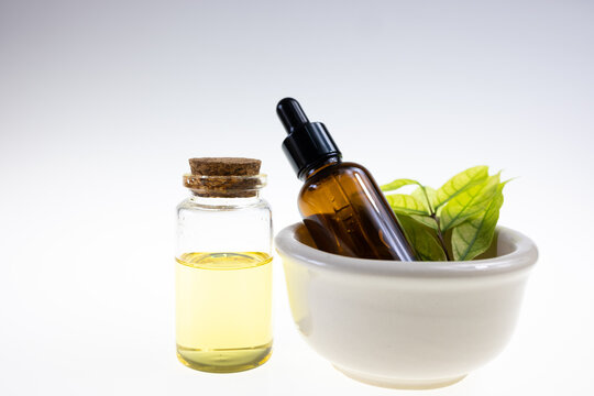 Aroma oil and herb on white background