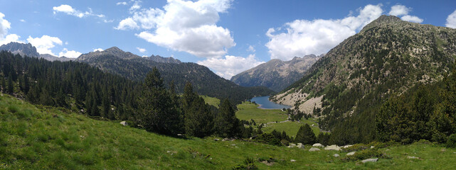 Naklejka na ściany i meble Landscape in the National Park of Aigüestortes. View of the Lake Llong and the valley. Spain.