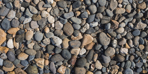 Background of stones from the sea, occupying the entire screen