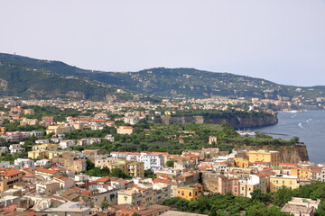 Fototapeta na wymiar Landscape of Sorrento, Naples, Italy, West Europe. View of village on the shore cliff. Mediterranean Sea.