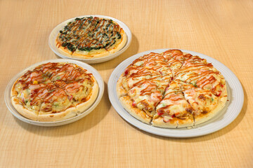 Italian pizza in white plate on wooden table