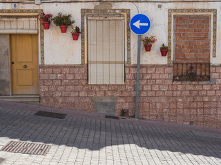 Downhill street with traditional houses at street level in the old town of Estepona, Costa del sol, Spain