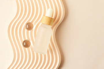 Cosmetics bottle with dropper,zero waste packaging with wooden cover. Box lying on the wavy podium.Pastel colors,good as mockup.