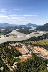 Aerial View of Fraser Valley with Canadian Nature Mountain Landscape Background. Harrison Mills near Chilliwack, British Columbia, Canada.