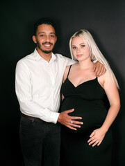 Stylish, proud and happy multi-ethnic couple expecting a baby