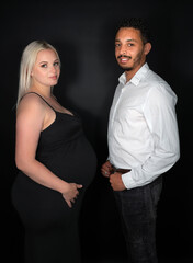 Stylish and happy multi-ethnic couple expecting a baby