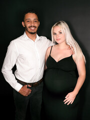 Stylish, proud and happy multi-ethnic couple expecting a baby