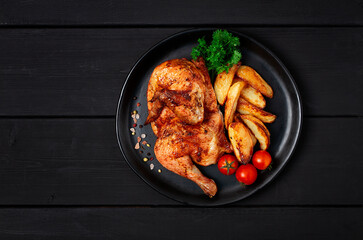 Fried Tobacco chicken, top view,   on a black wooden table, no people, selective focus, Georgian dish, toned,