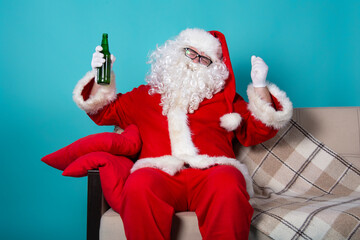 Funny santa claus drinks beer.