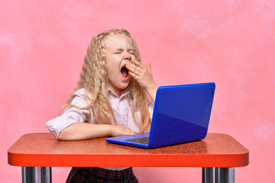 tired schoolgirl falls asleep at the laptop. online learning concept