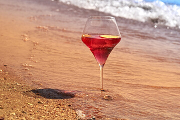Wine glass with a cocktail by the sea.