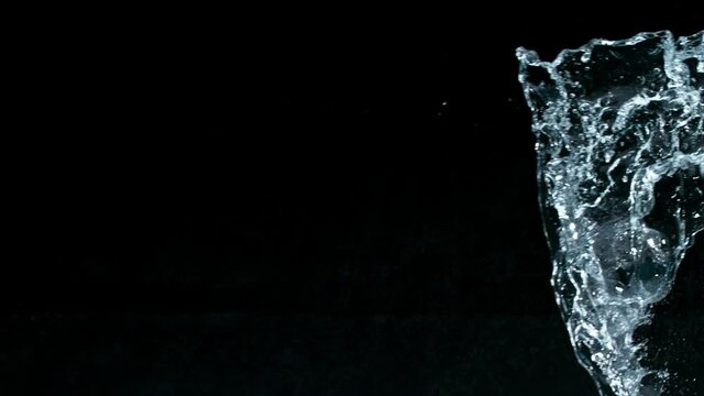 Super slow motion of water splash on black background. Filmed on high speed cinema camera, 1000 fps.