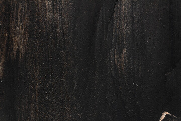 Black painted metal texture with smudges, scratches and gold sparkles