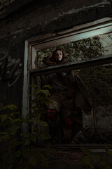 Fototapeta na wymiar Stalker woman surviving in abandoned places