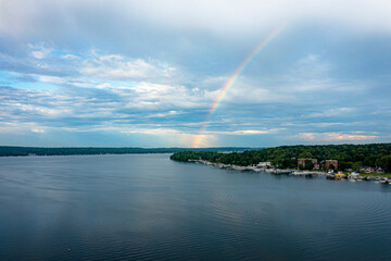 Naklejka na ściany i meble Aerial Image of a Rainbow over a lake