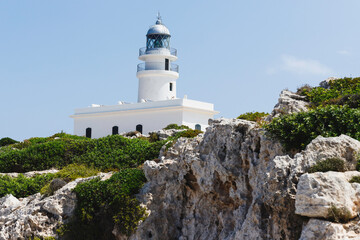 Fototapeta na wymiar Image of a lighthouse or light signaling tower located on the sea coast. Tourism, travel, coast landscape