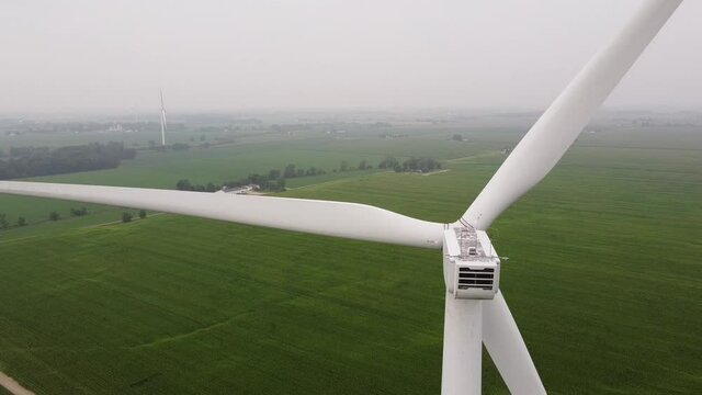 Wind Turbine Spins During Foggy Weather Within DTE Wind Farm In Ithaca, Michigan, USA. static shot