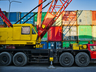 big mobile crane parking near the container zone location at the harbour
