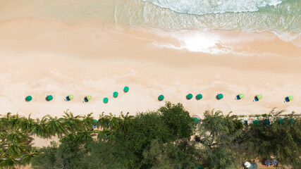 Top view.Panorama beautiful beach with white sand on sunny day. palm trees umbrellas sunset  summer holiday. 