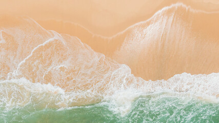 Top view or aerial view of Beautiful crystal clear water and white beach.Fantastic colorful sunset on surfing  coastline.Waves rolling from above breaking beach.