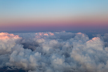Fototapeta na wymiar Pink skyline and clouds from the plane